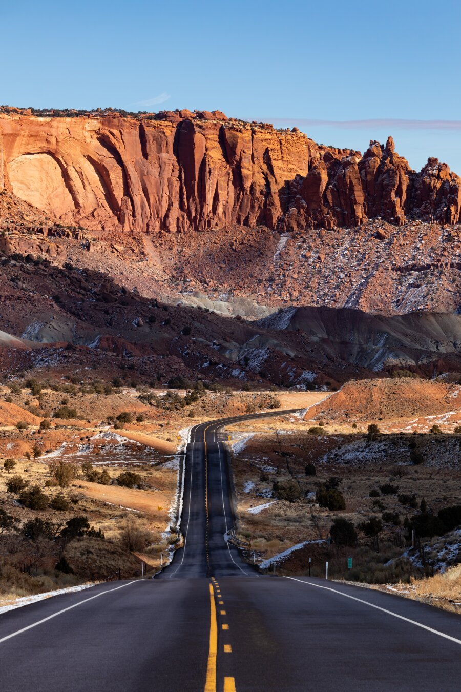A lonely road leads directly into the red mountains of Capitol Reef National Park.