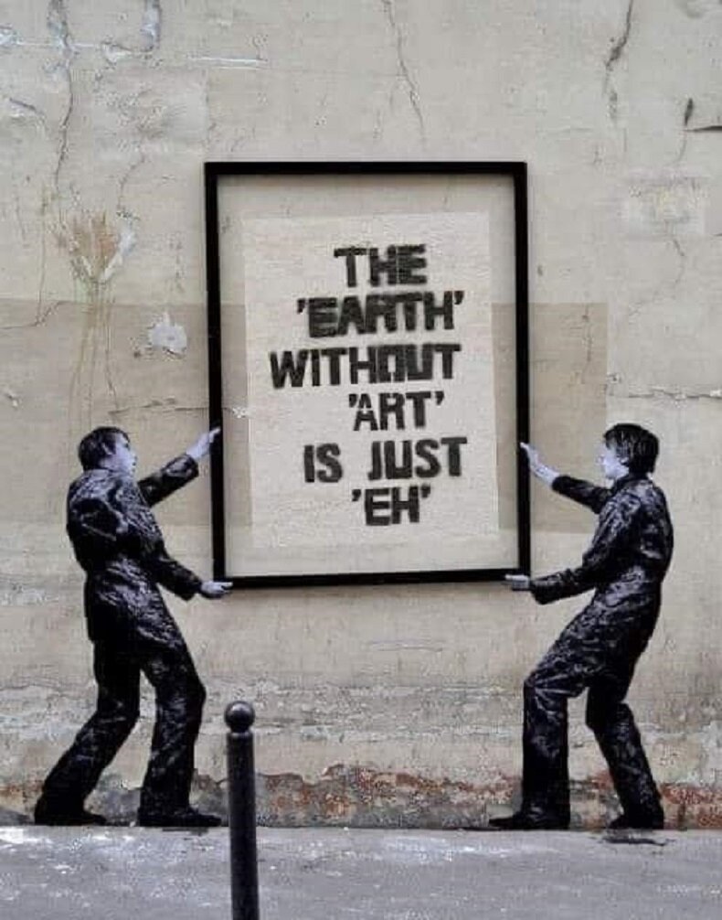 Street art depicting two figures hanging a framed poster that reads, "The 'Earth' without 'Art' is just 'Eh'."