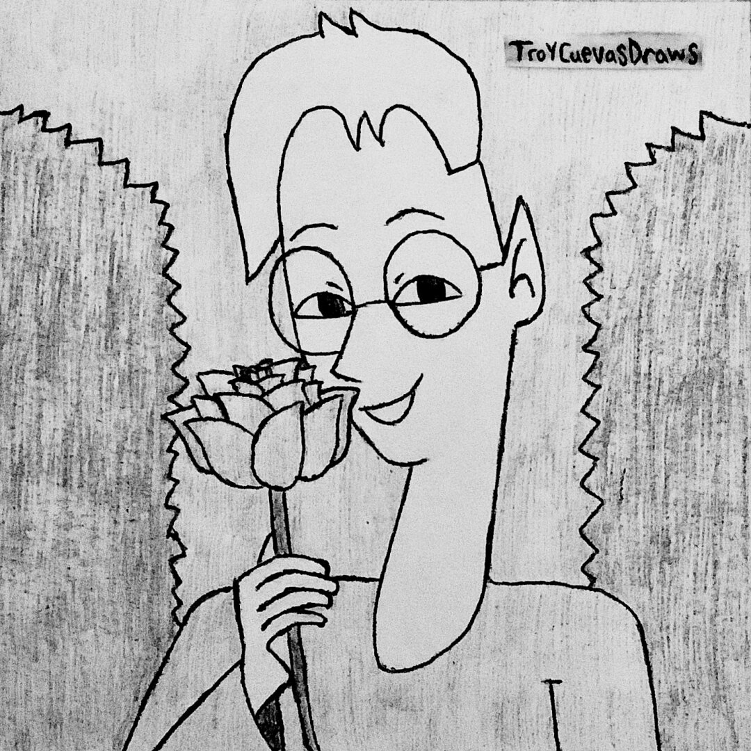 Hunter Scriver (the elven editor) holding a rose flower (possibly a Hunter rose) in front of two hedge bushes.