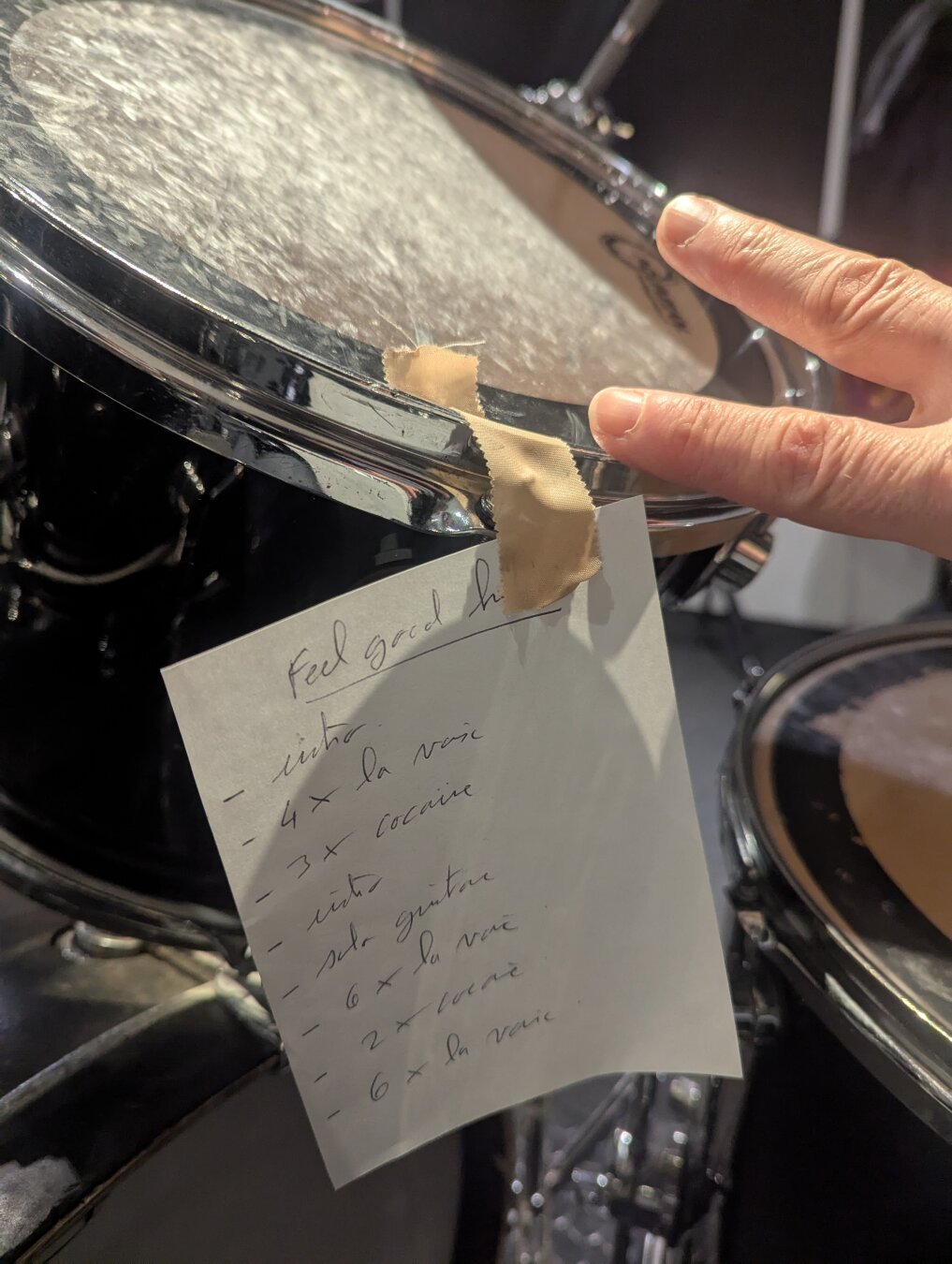 A cue sheet attached to a drum head with some tape