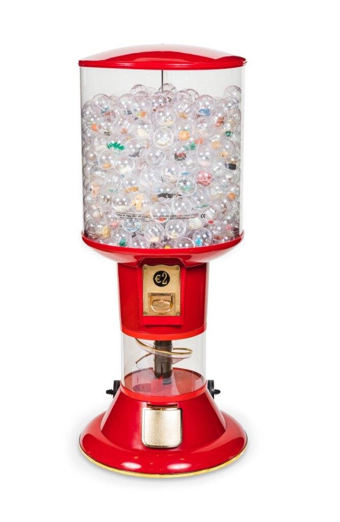 Red vending machine filled with transparent balls in which toys in various colours can be seen.