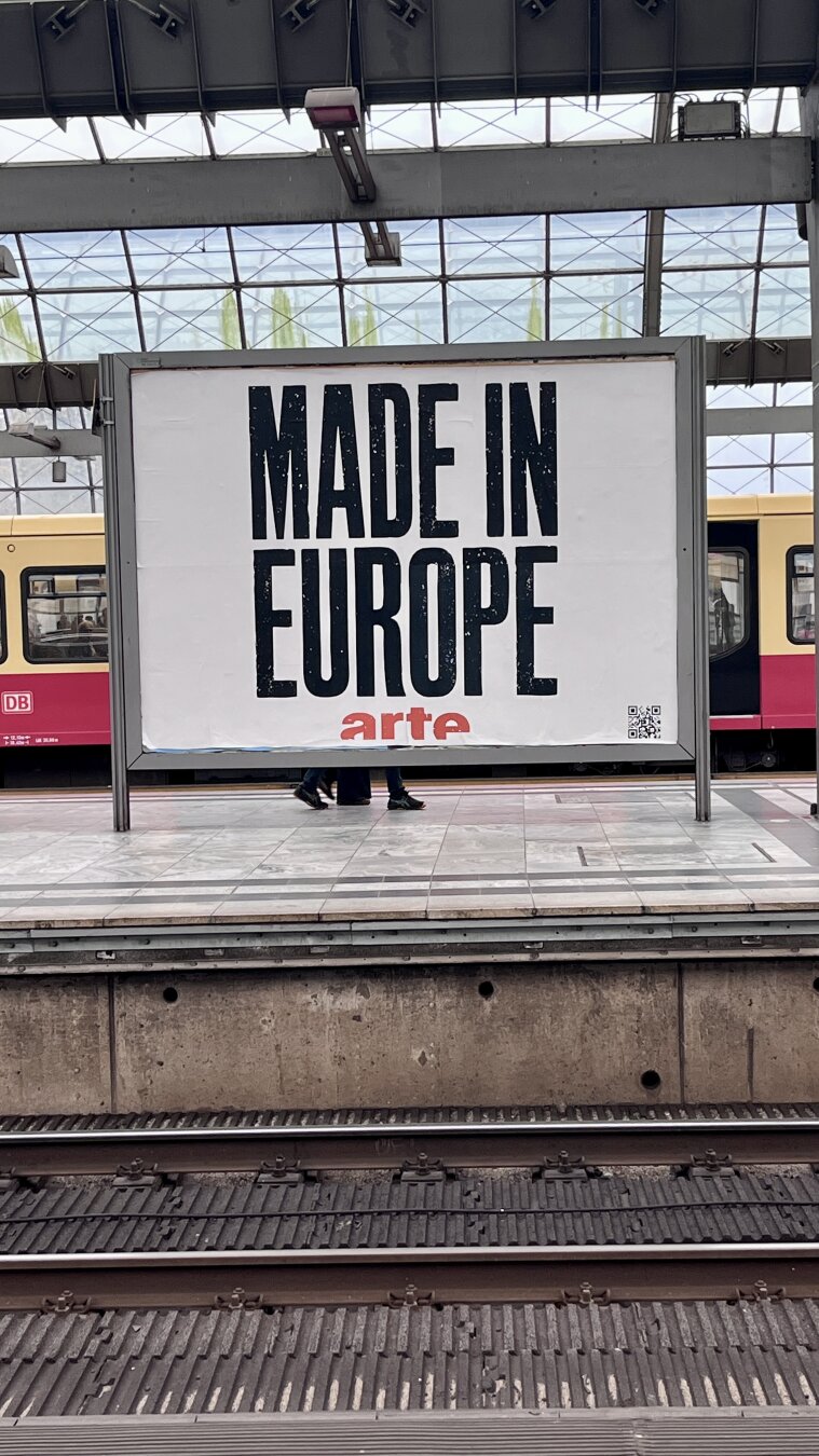 18/1 Poster at Berlin Spandau station with the lettering "Made in Europe" by arte with S-Bahn in the background.