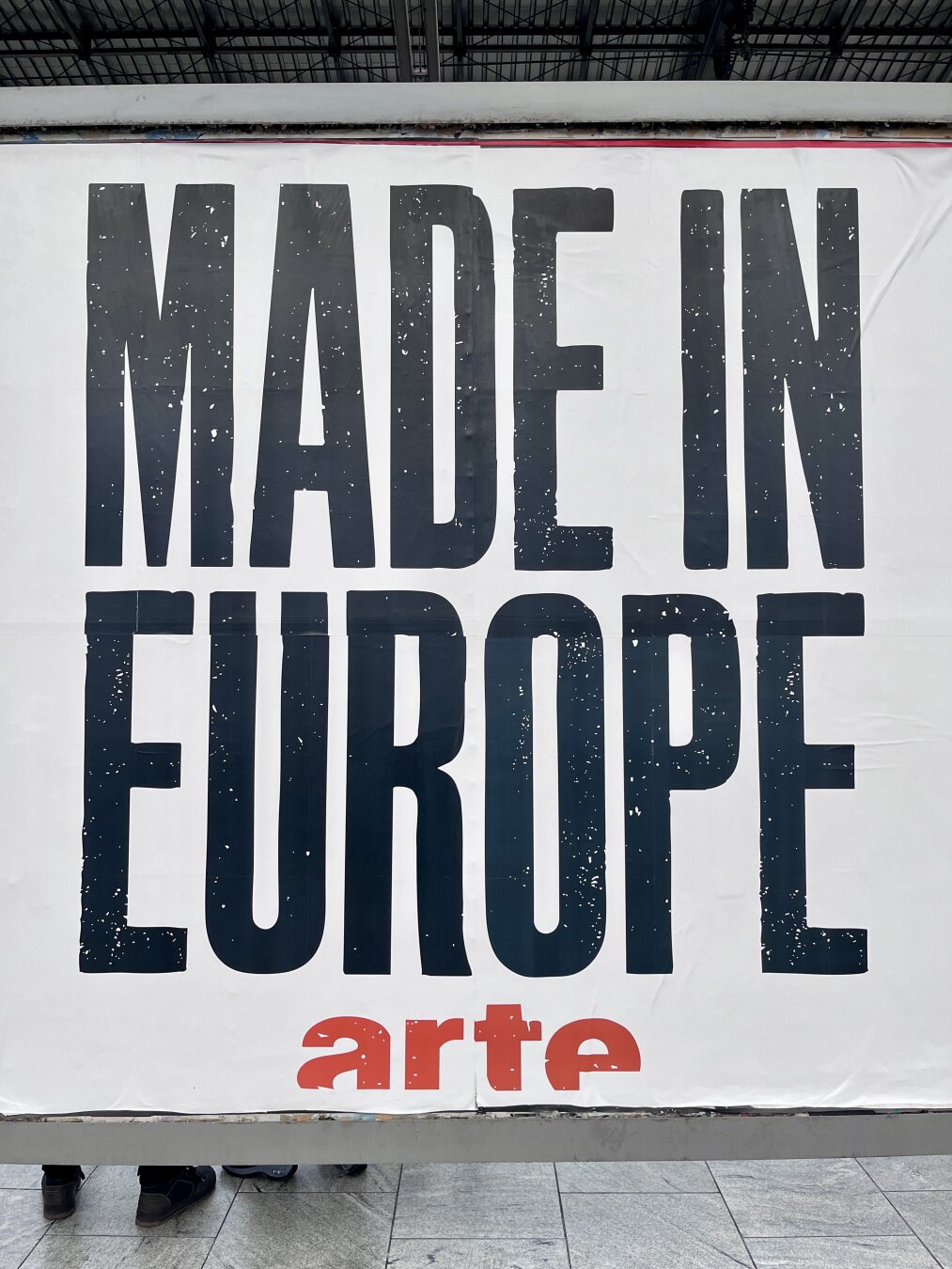 18/1 Poster at Berlin Spandau station with the lettering "Made in Europe" by arte.