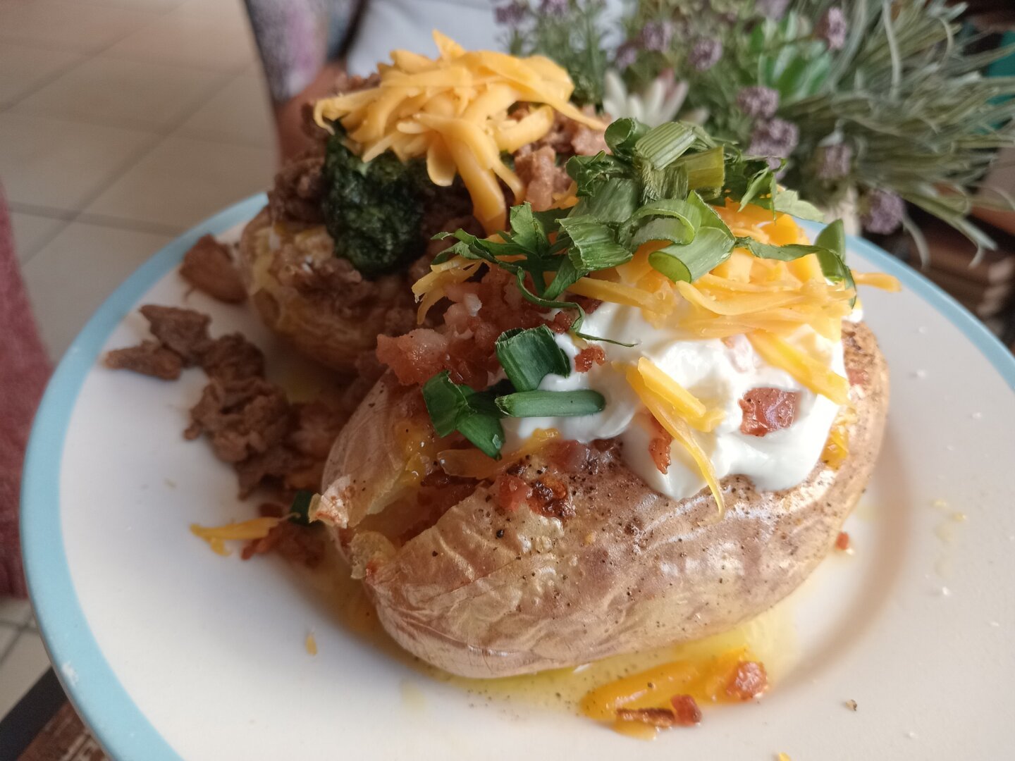 2 baked potatoes with toppings