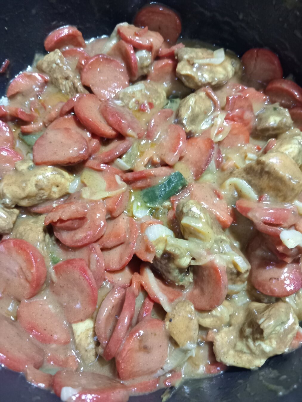 New Orleans Etouffee with sausage and chicken boiling in a pot