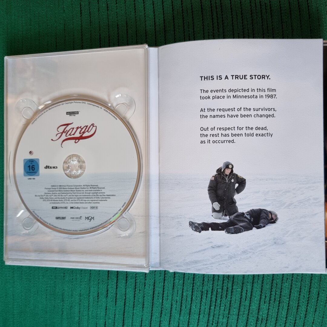 Opened up first page, with disc on left tray