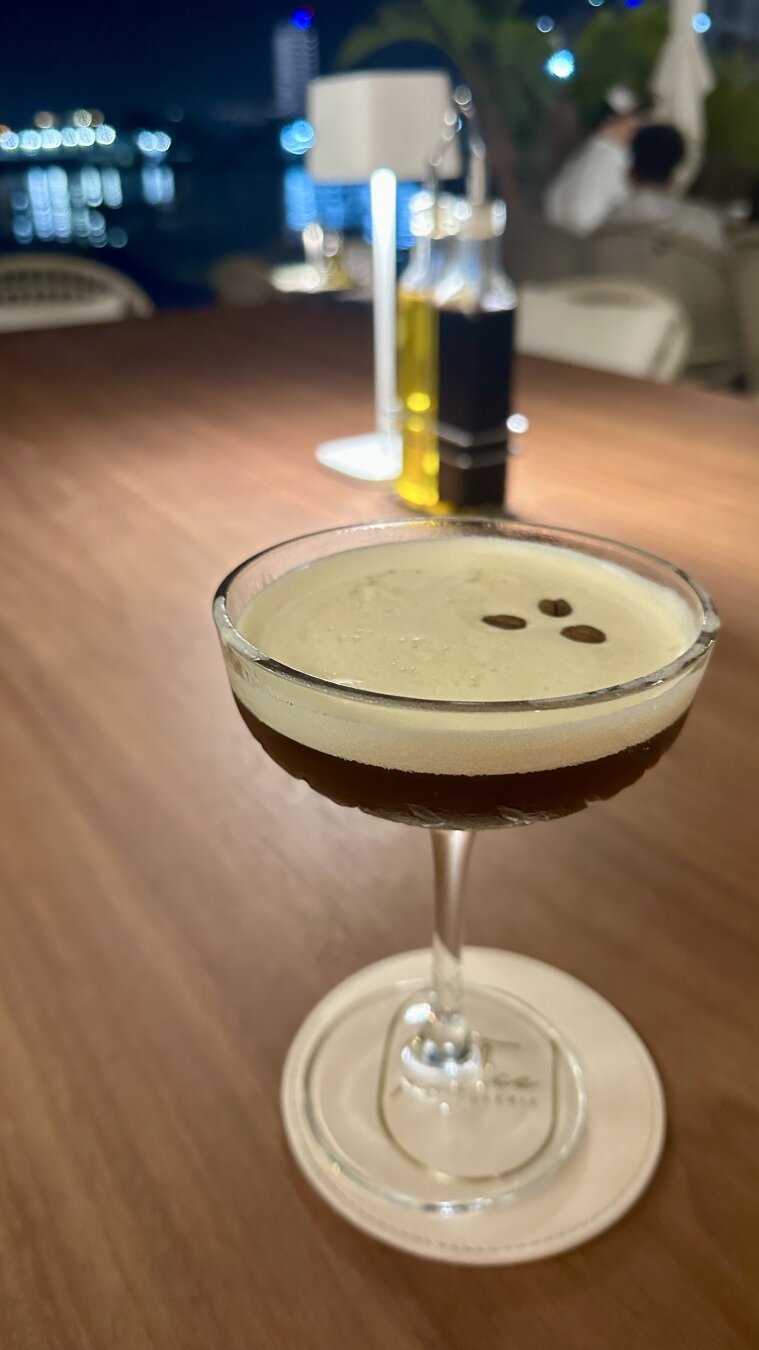 A focused espresso martini on a table with a blurred background in a bar in Malta 🇲🇹