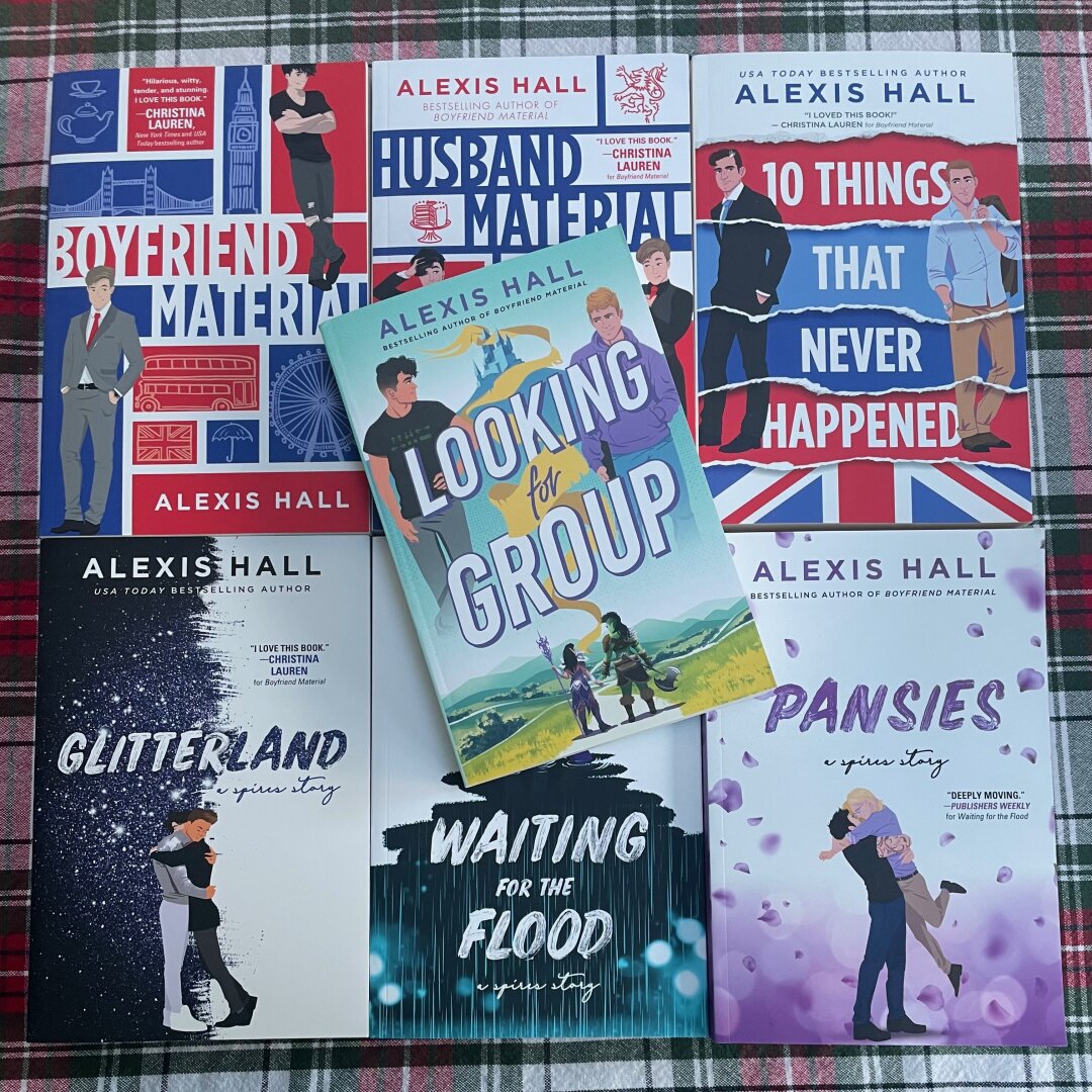 A selection of Alexis Hall books displayed on a table.