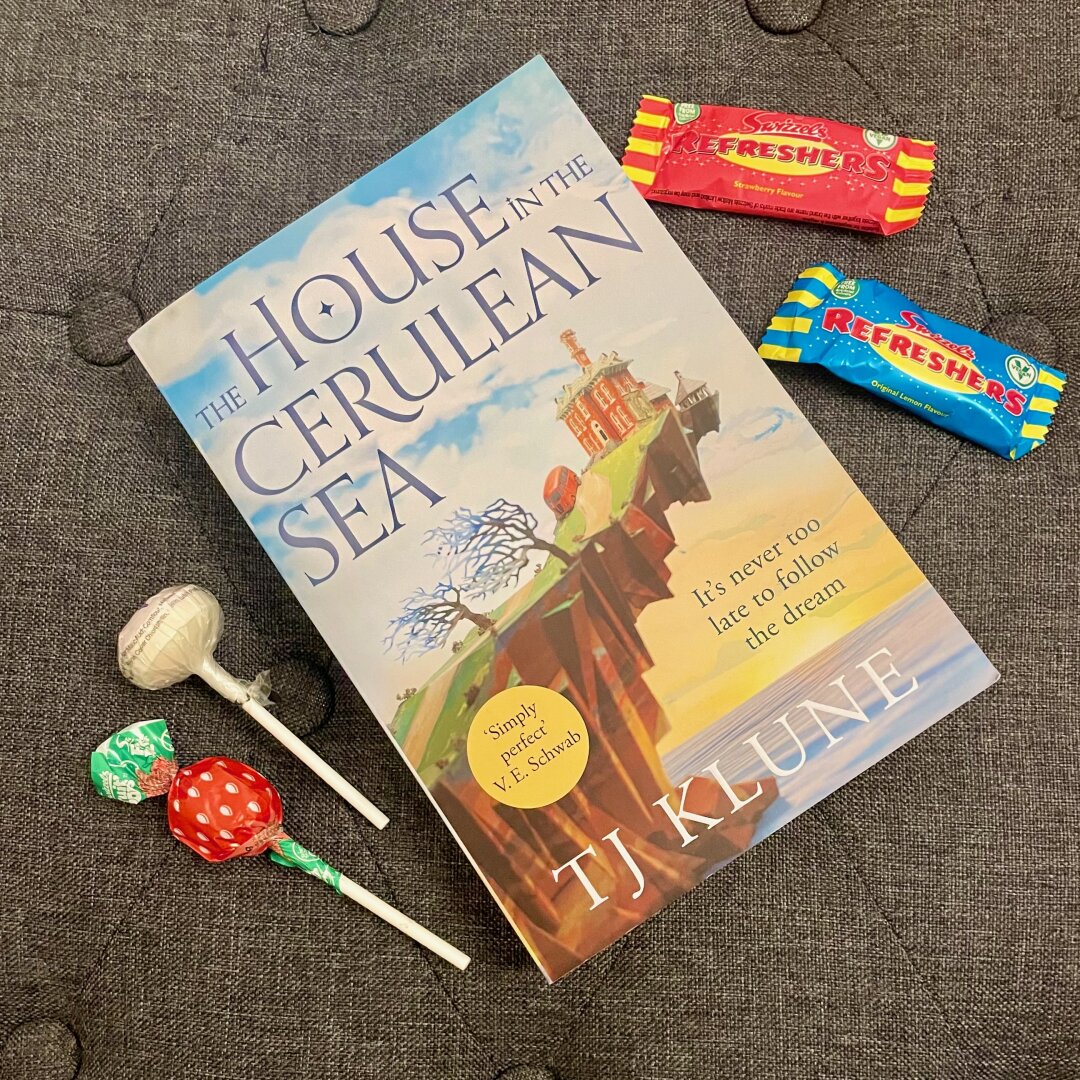 A paperback book surrounded by retro sweets.