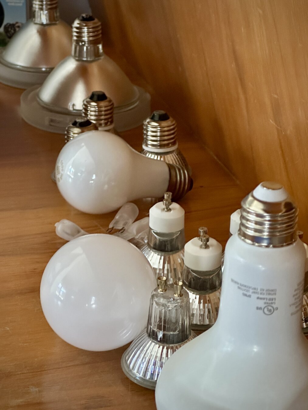 An oddball hodge-hodge assortment of incandescent and halogen light bulbs, recently replaced by energy saving LED counterparts.