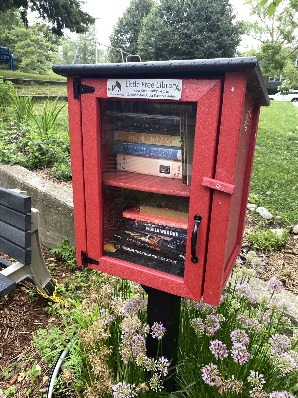 Little Free Library charter #167052 , which has a red-colored base, and matching door.