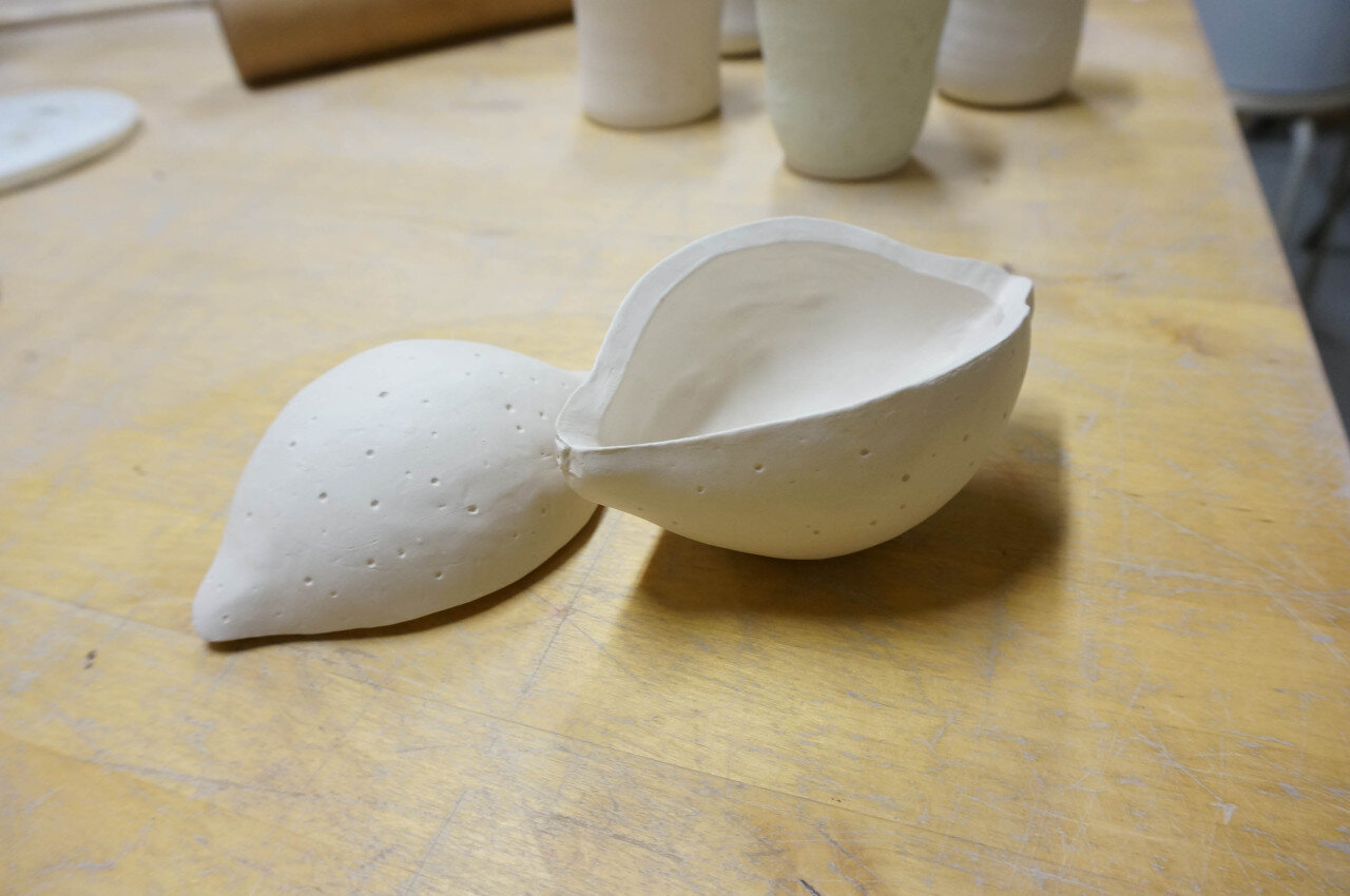 A colour photo of a ceramic box in the shape of a lemon.