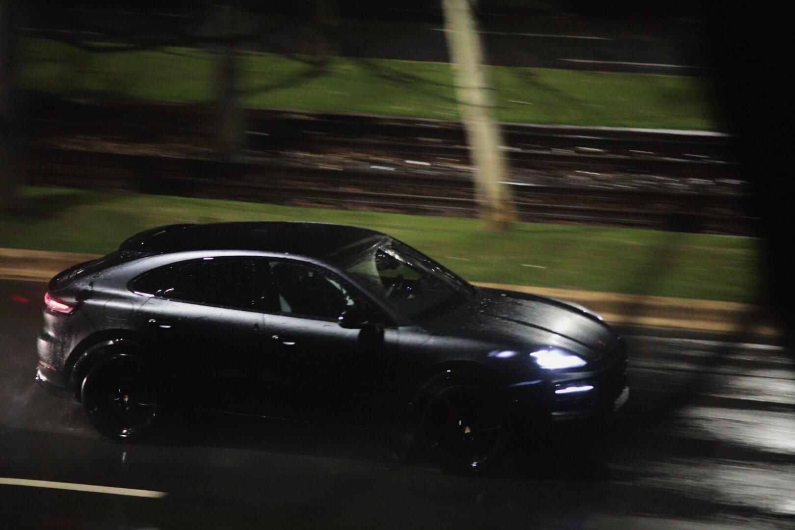 Porsche cayenne running at night in the rain