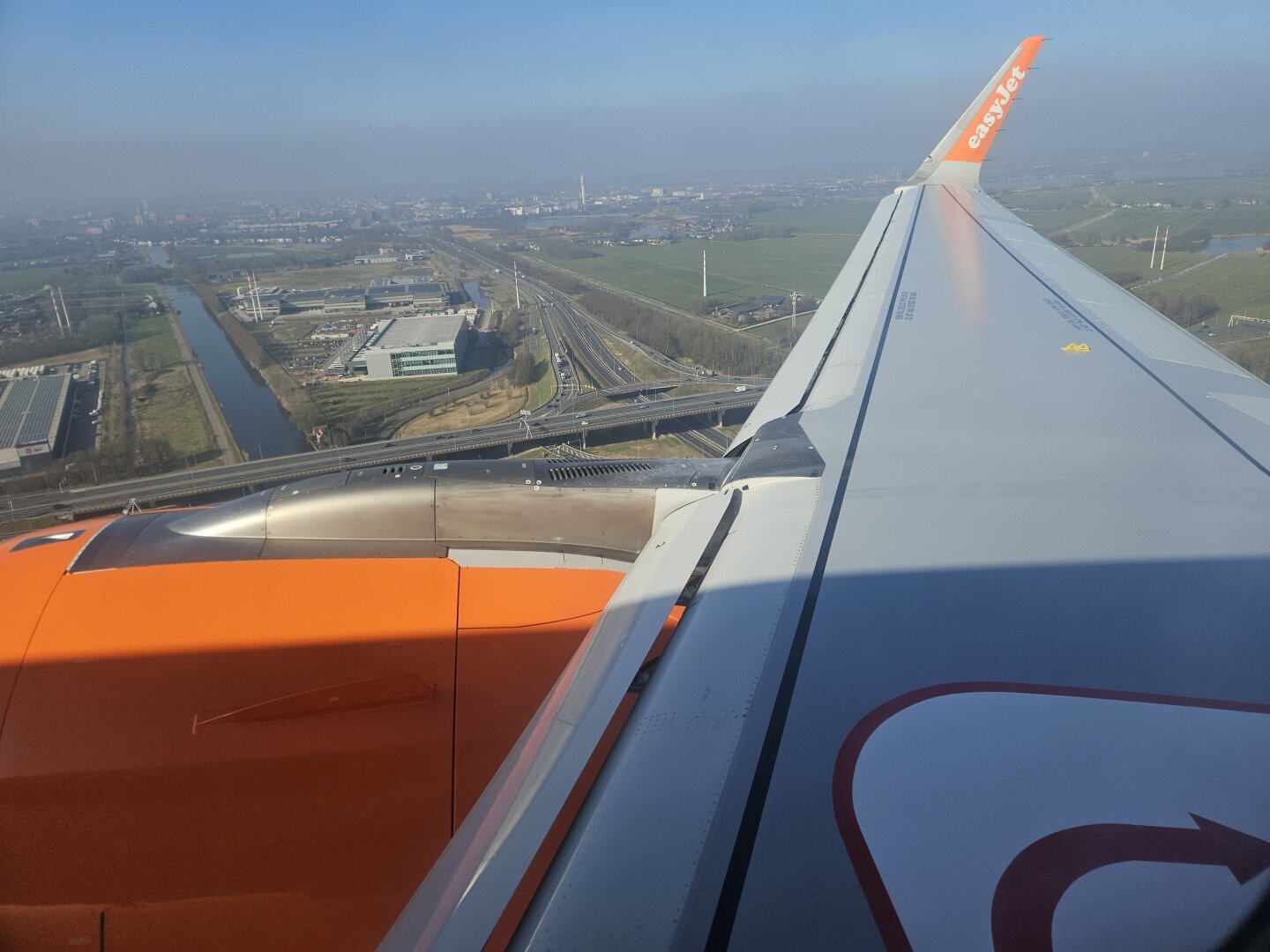 view of motorways near Hoofddorp with airplane wing and engine in foreground