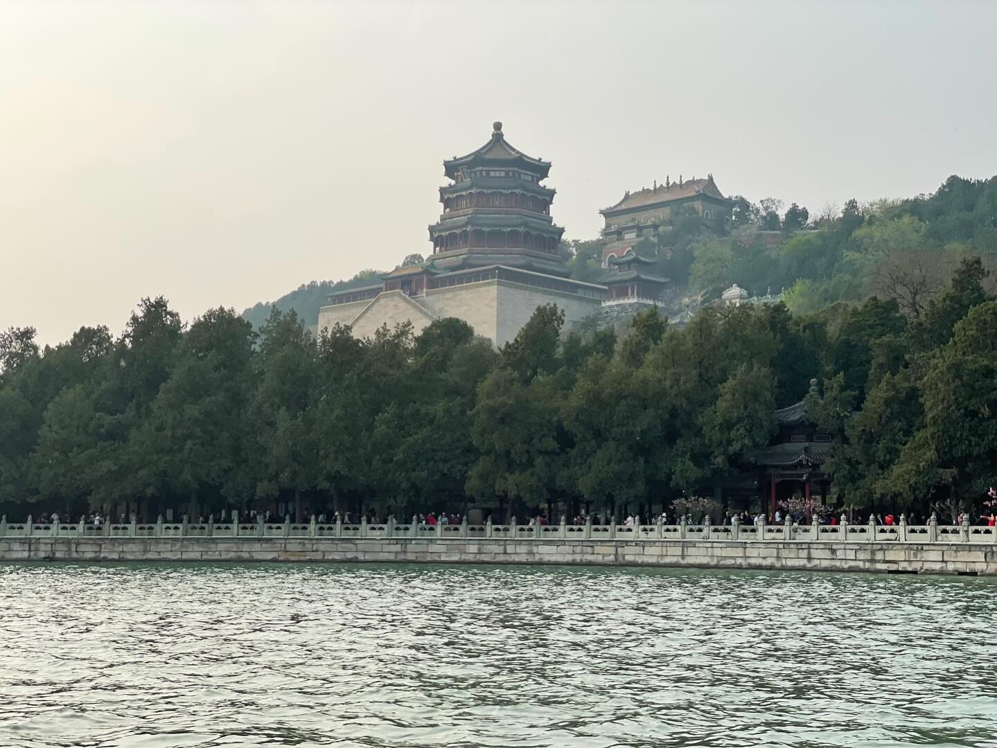 A palace on a hill overlooking a lake.