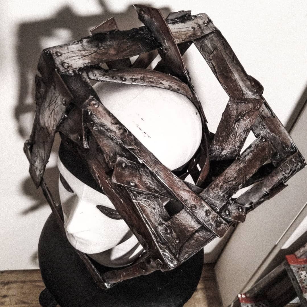 The mask is supposed to represent a head jammed into a frame - a symbol of thought barriers and narrow-mindedness