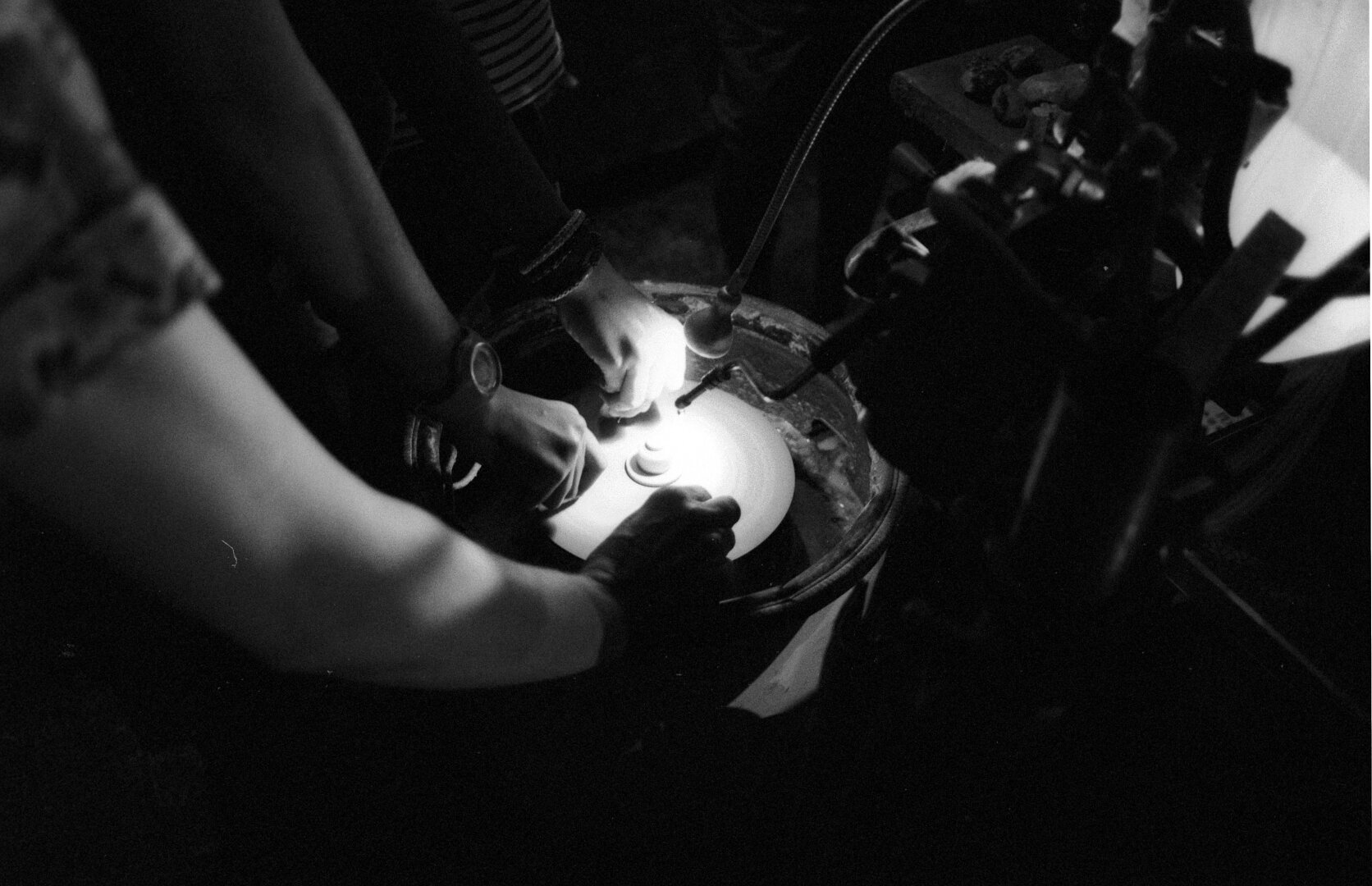 People polishing stones on a homemade machine during a festival.
