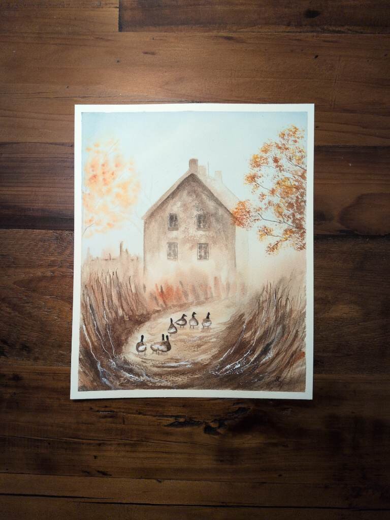 This is a misty watercolor countryside painting with a cottage and a path among tall grasses. It's painted in an 8x10 portrait orientation on Arches Coldpress watercolor paper. Lots of browns in this painting with pops of orange here and there. The mist creates distance with the backside of the cottage, a fall tree on the left, and the mid ground foliage. Branches lit with orange leaves peak in on the right side covering a corner of the cottage roof. The path in the center fades into the mist at mid ground and guides a gaggle of geese towards the cottage. Tall grasses swoop towards the path on both sides.