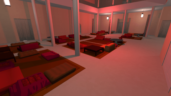 Blick über einen Raum mit hellorange-pastellfarbenen Wänden, weißen Säulen und roten Teppichen, auf denen Sitzpolster und Kissen in Orange- und Rottönen angeordnet sind.