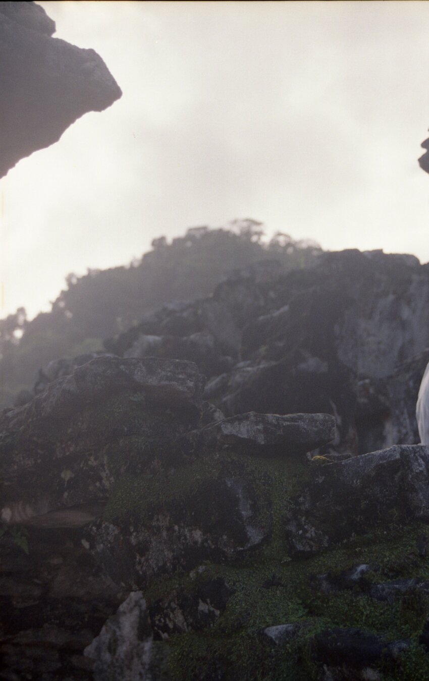 A hilly ruin in darkness under a bright sky