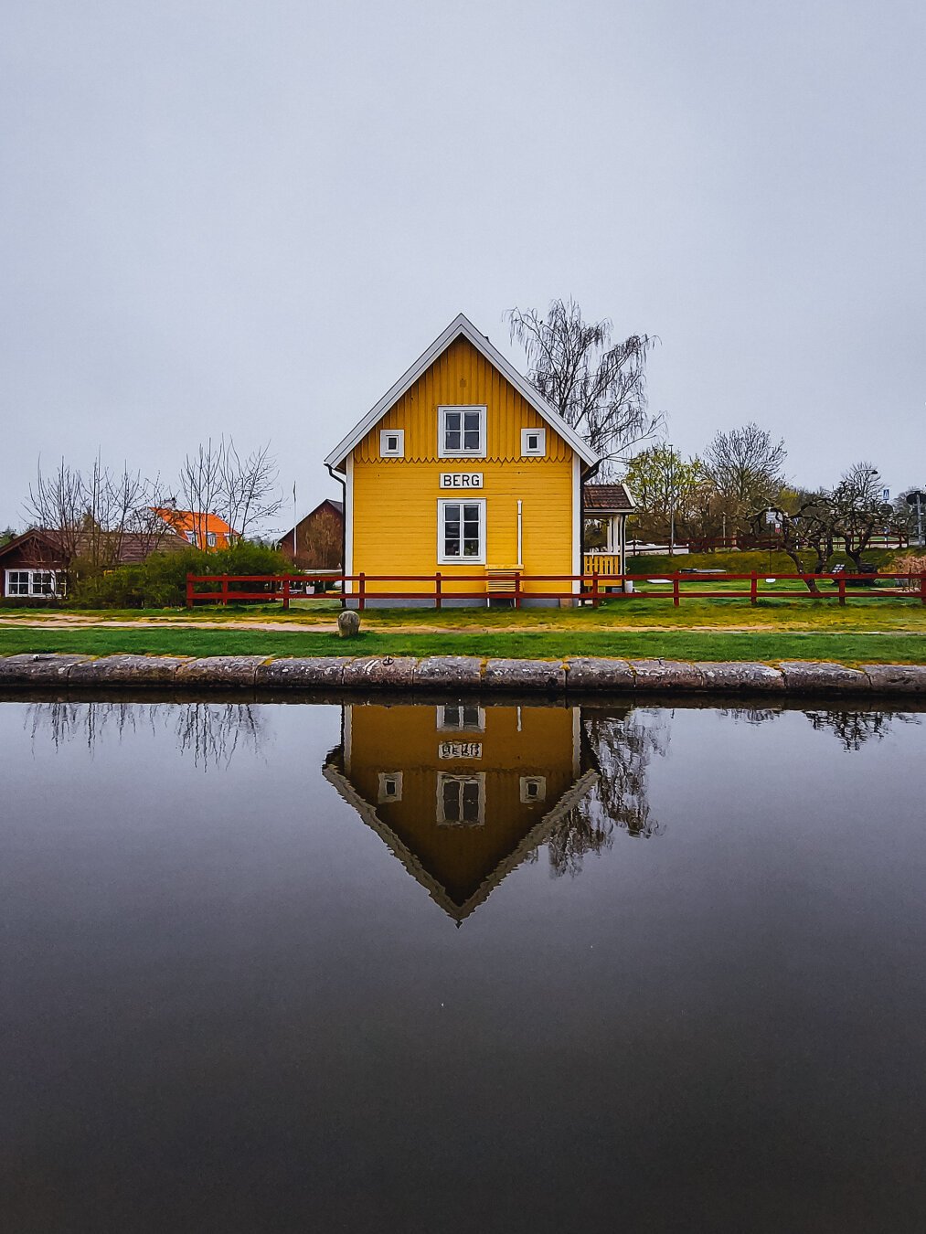 A little yellow cottage by the locks at Göta Canal in Östergötland County, Sweden.