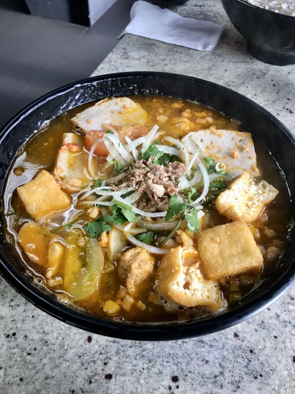 Crab with tofu puff, fishcake, brown rice noodles, tomato soup