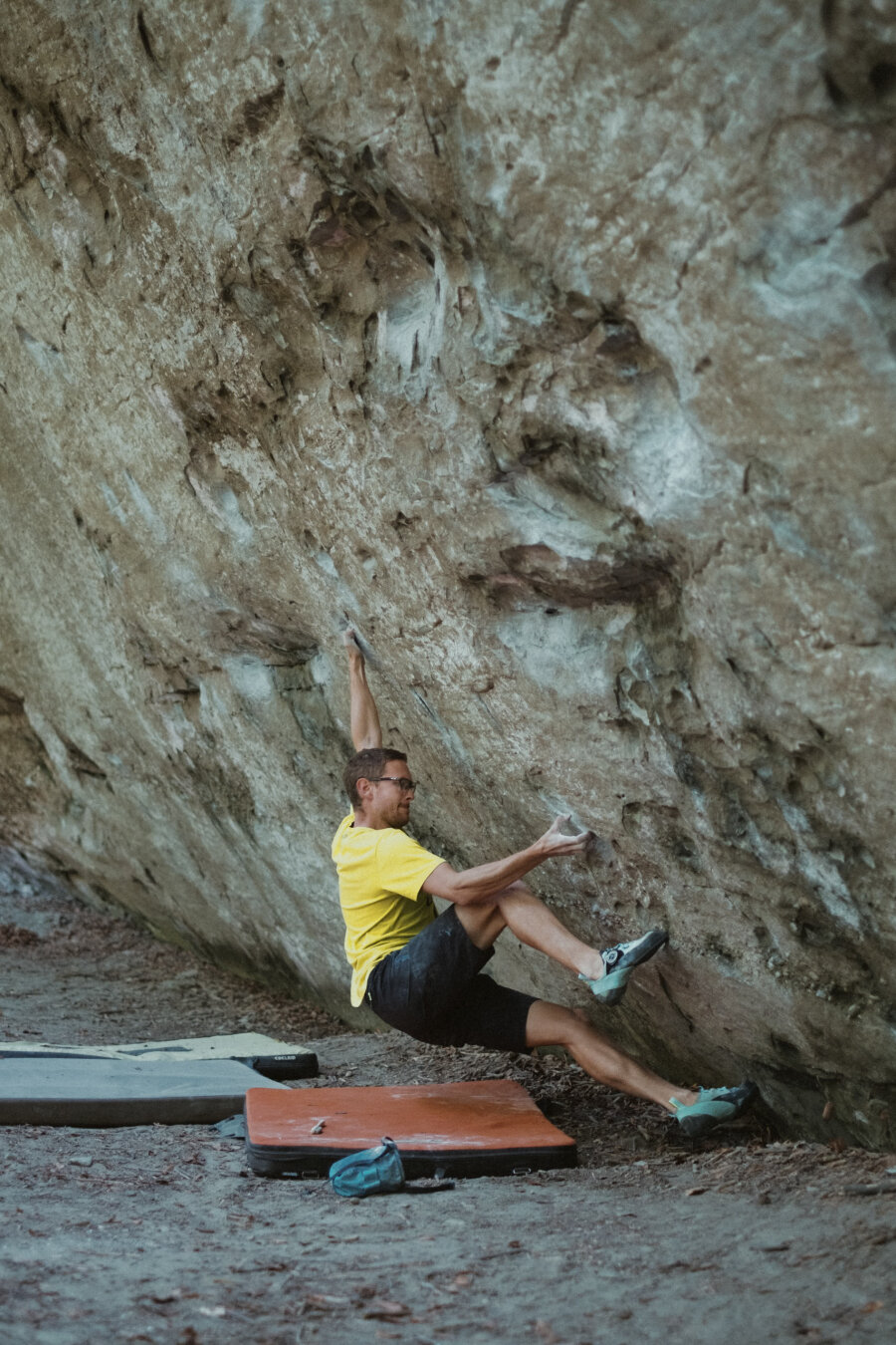 A photograph of a man bouldering.