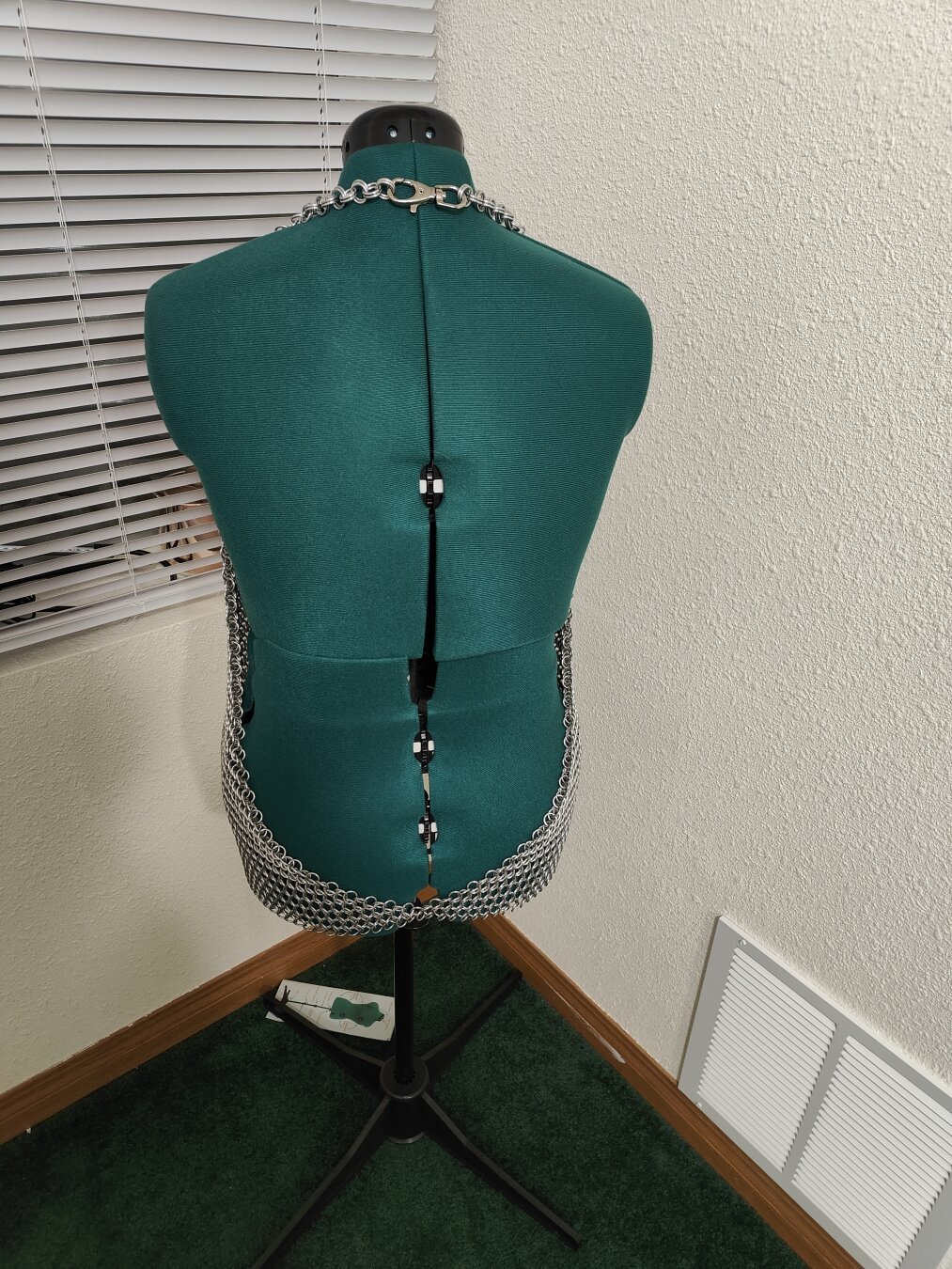 A back view of the chainmail shirt described in the post. It is modeled on a mannequin with a plain background.