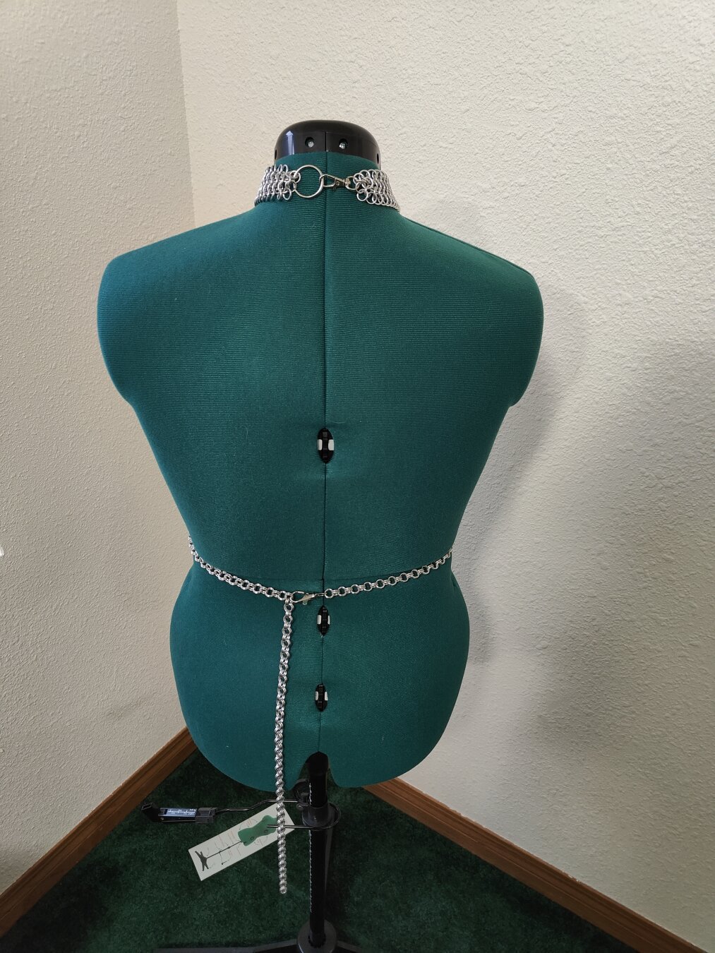 A back view of the piece described in the post. It is modeled on a mannequin with a plain background.
