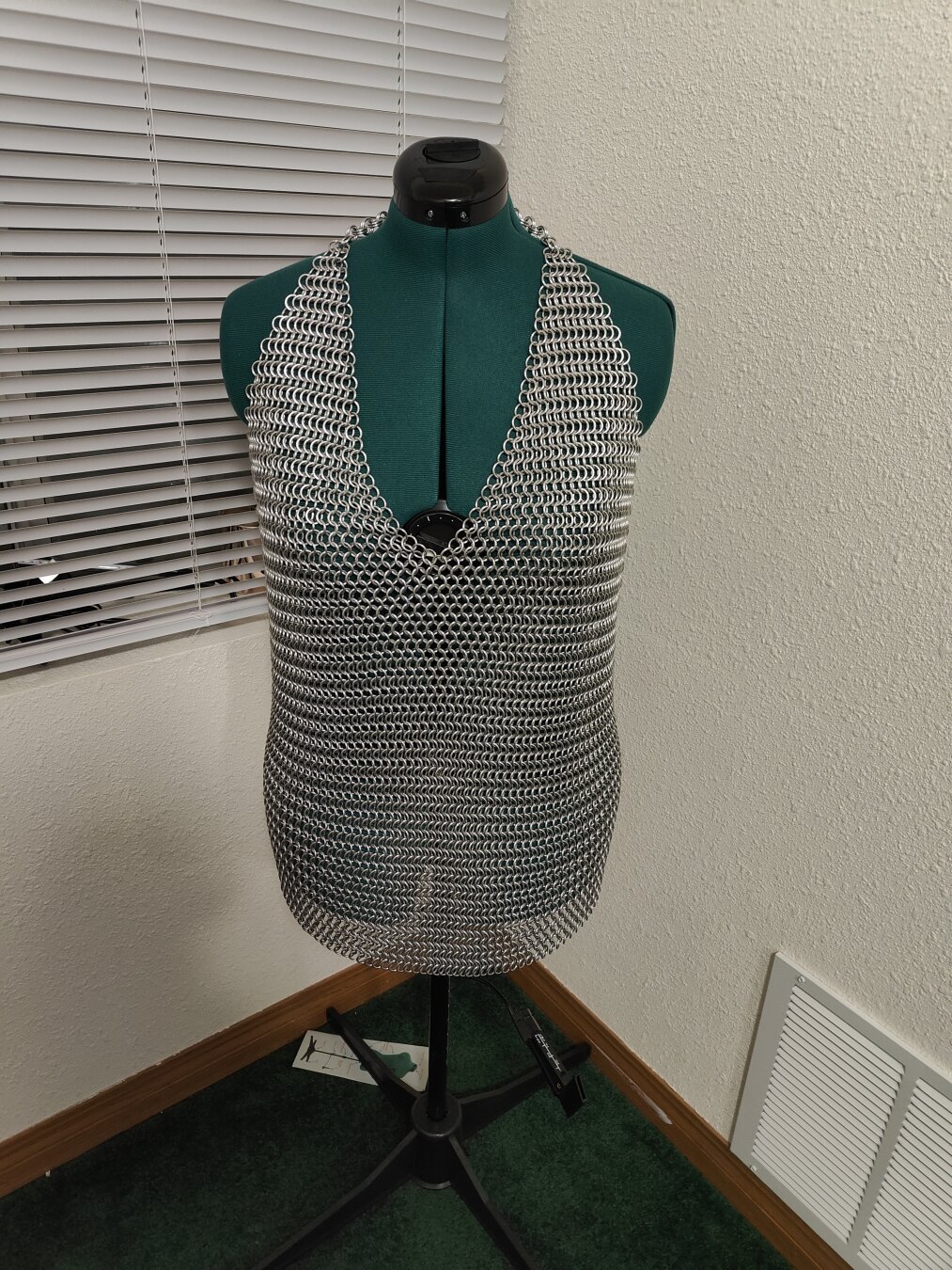 A front view of the chainmail shirt described in the post. It is modeled on a mannequin with a plain background.