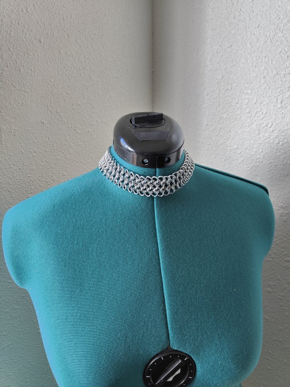 A front view of the chainmail choker described in the post. It is modeled on a mannequin with a plain background.