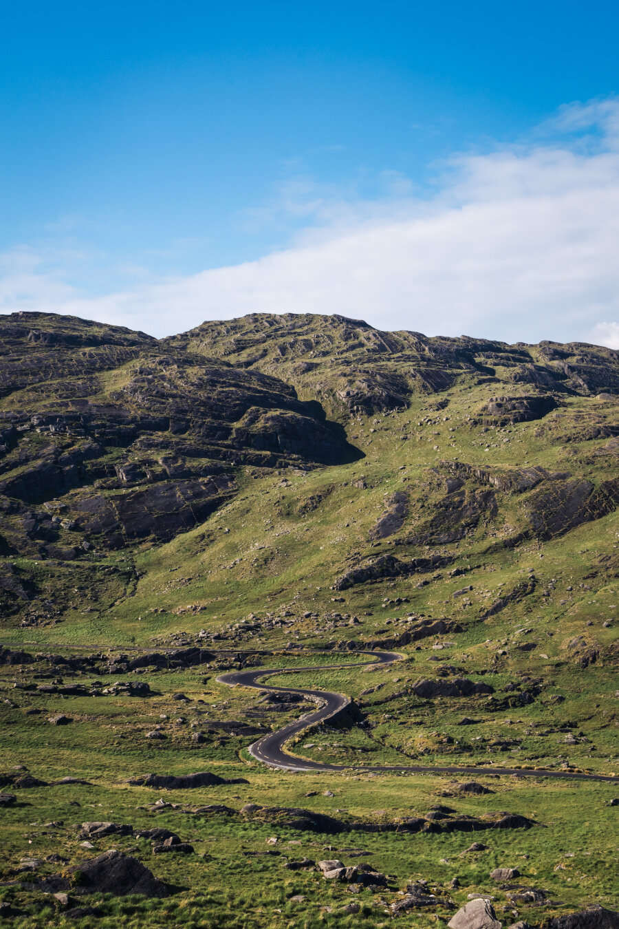 a narrow, windy road in a valley a narrow, windy road in a valley