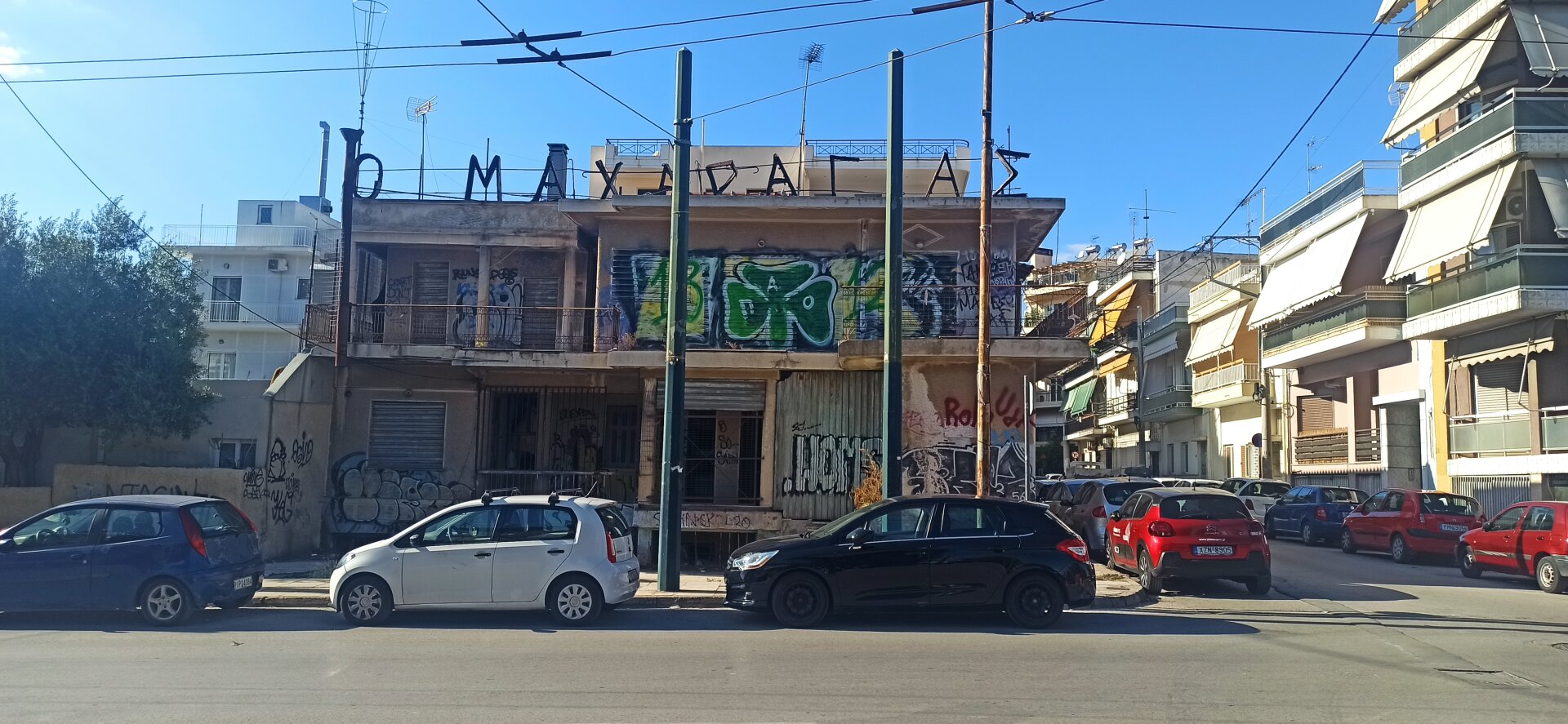 It's a photo of once glamorous building now in ruin. In front of the building, there are awkward and non-symetciral metal poles that disrupt the photo.