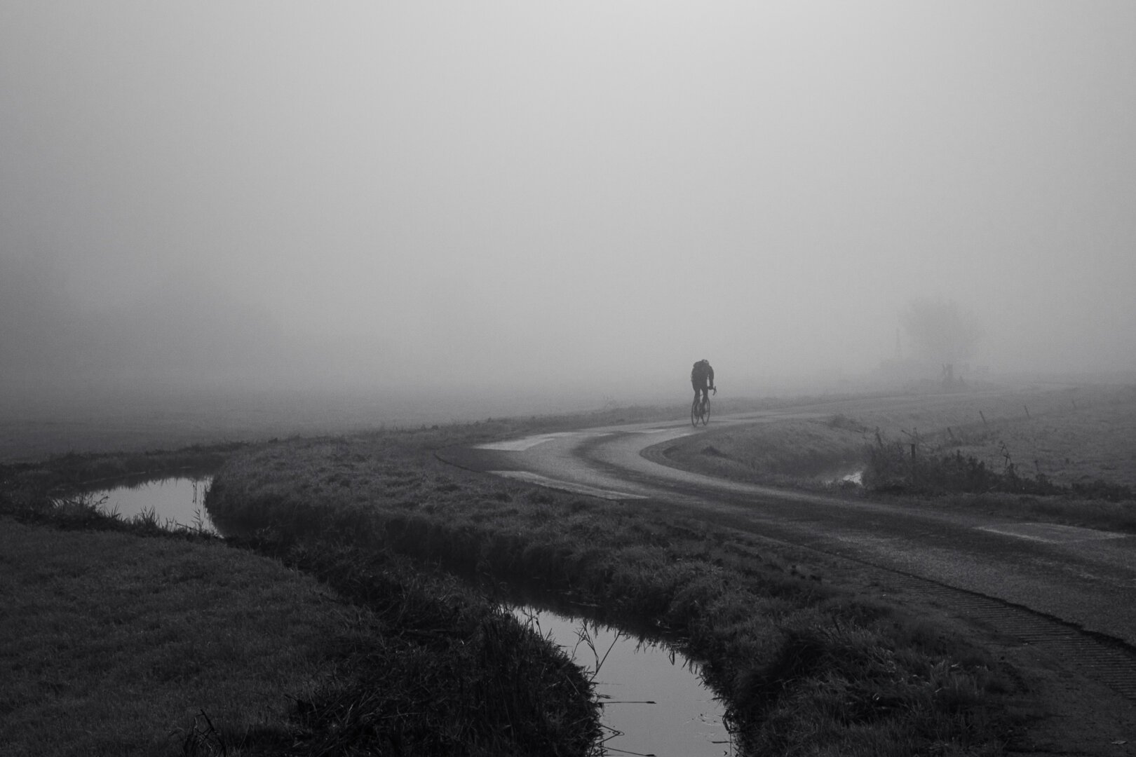Cyclist in the fog at Krommenie, Netherlands