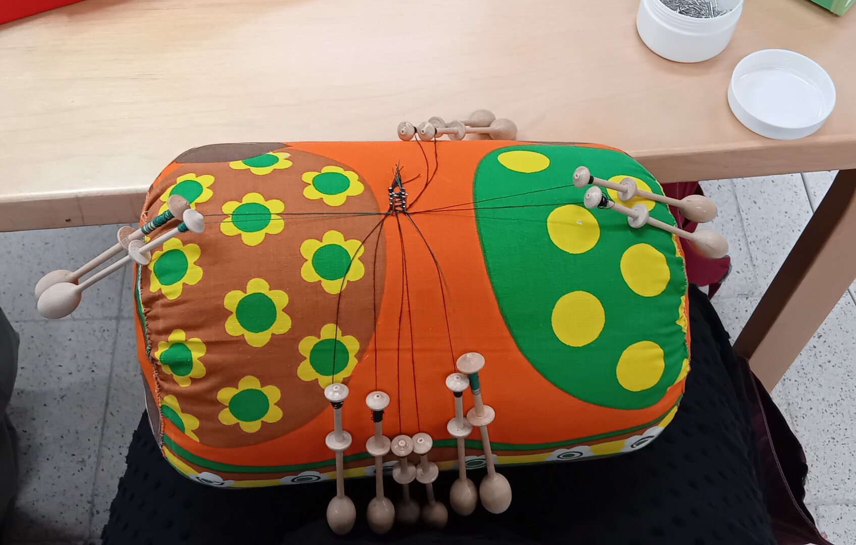 Bobbin lace roller pillow with ongoing work