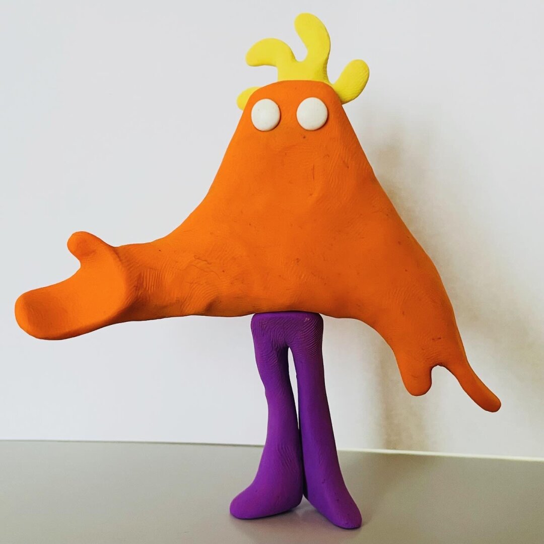 The same orange clay character, but in a different pose