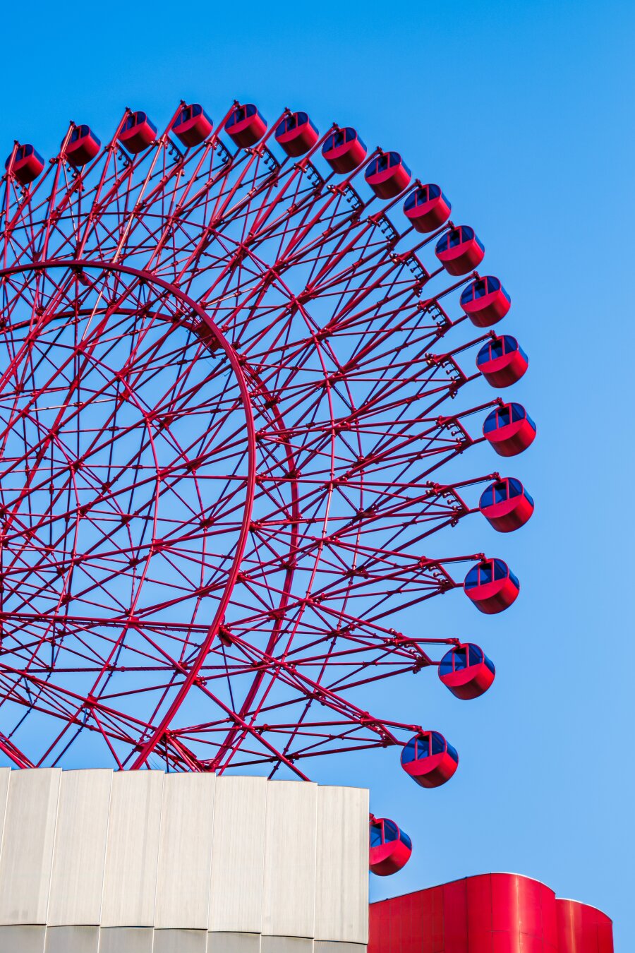 The iconic HEP FIVE ferris wheel in Osaka, Japan, with a blue sky in the background.
