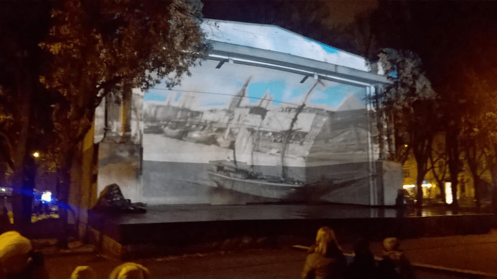 Black and white cutouts of Riga and a boat on the Daugava