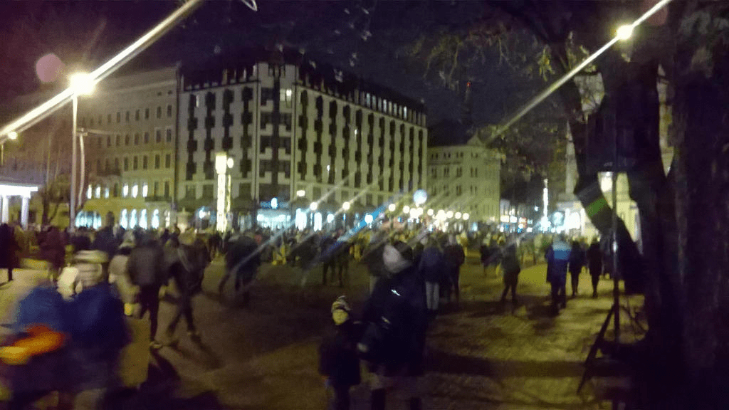 On the small bridge where the Freedom Monument is located, looking in the direction of Old Riga, a mass swarm of people moving to and from