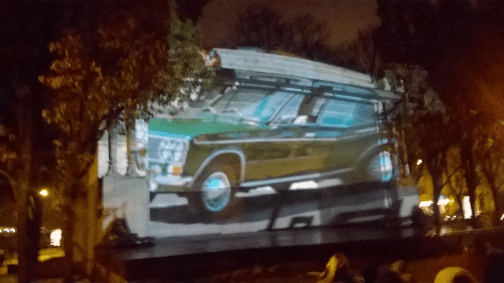 Old school green car driving by and away