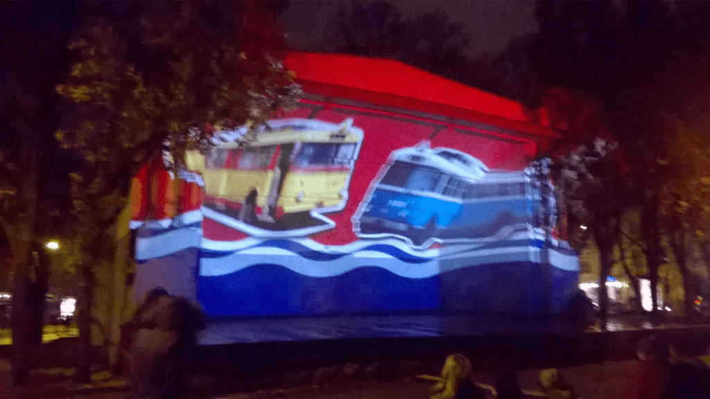 Occupation era flag, with old buses and trams rising from the water portion