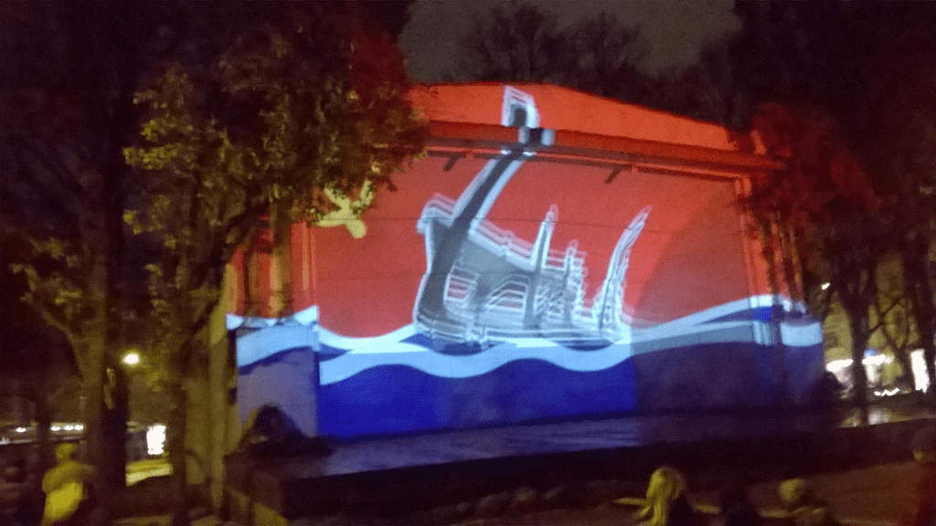 Occupation era flag, with a cutout of remains of an old boat popping from the water portion up