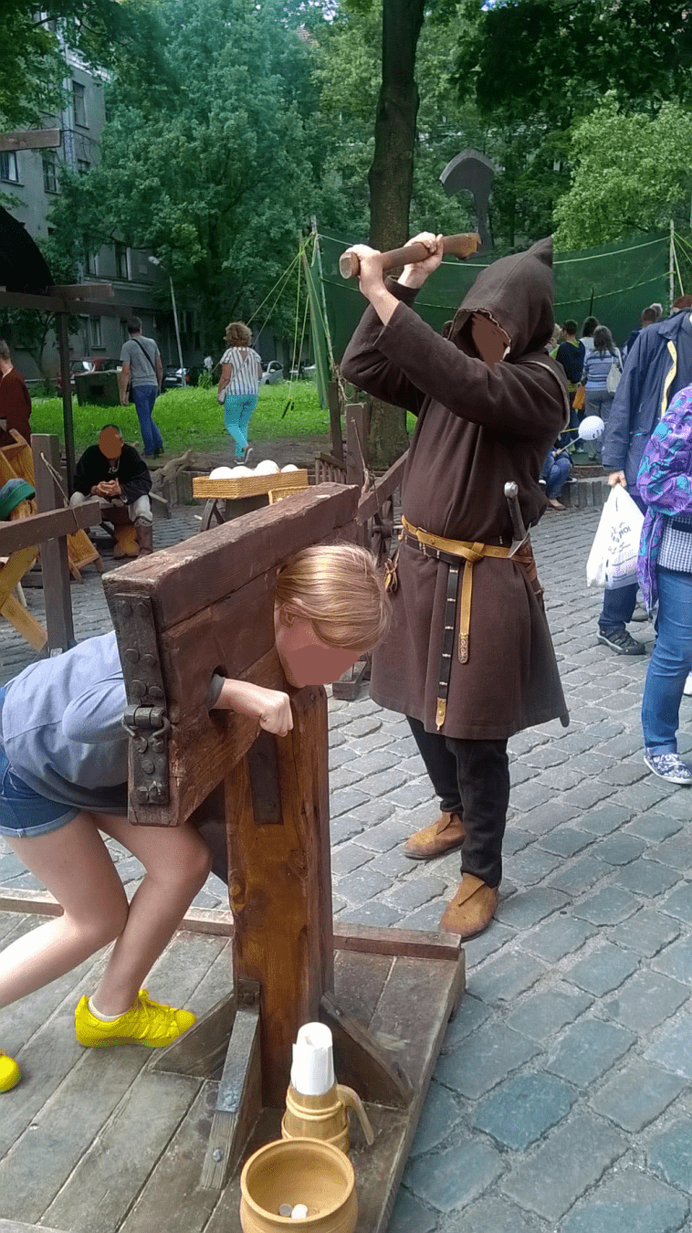 A young girl was in the stocks, with the axe raised and ready
