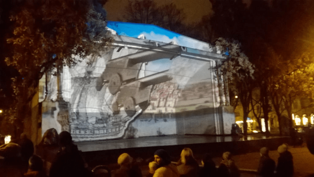 Cutout of a ship is sailing across the painting of Old Riga is now joined by cannons as they fire