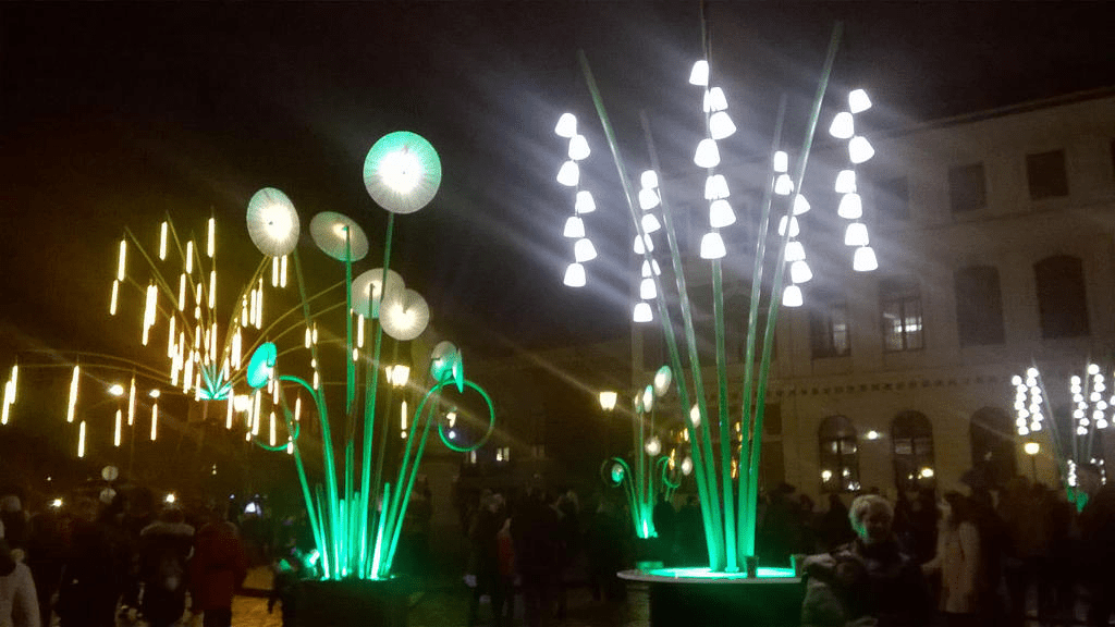 Art installations, in the shape of flowers, bright with light