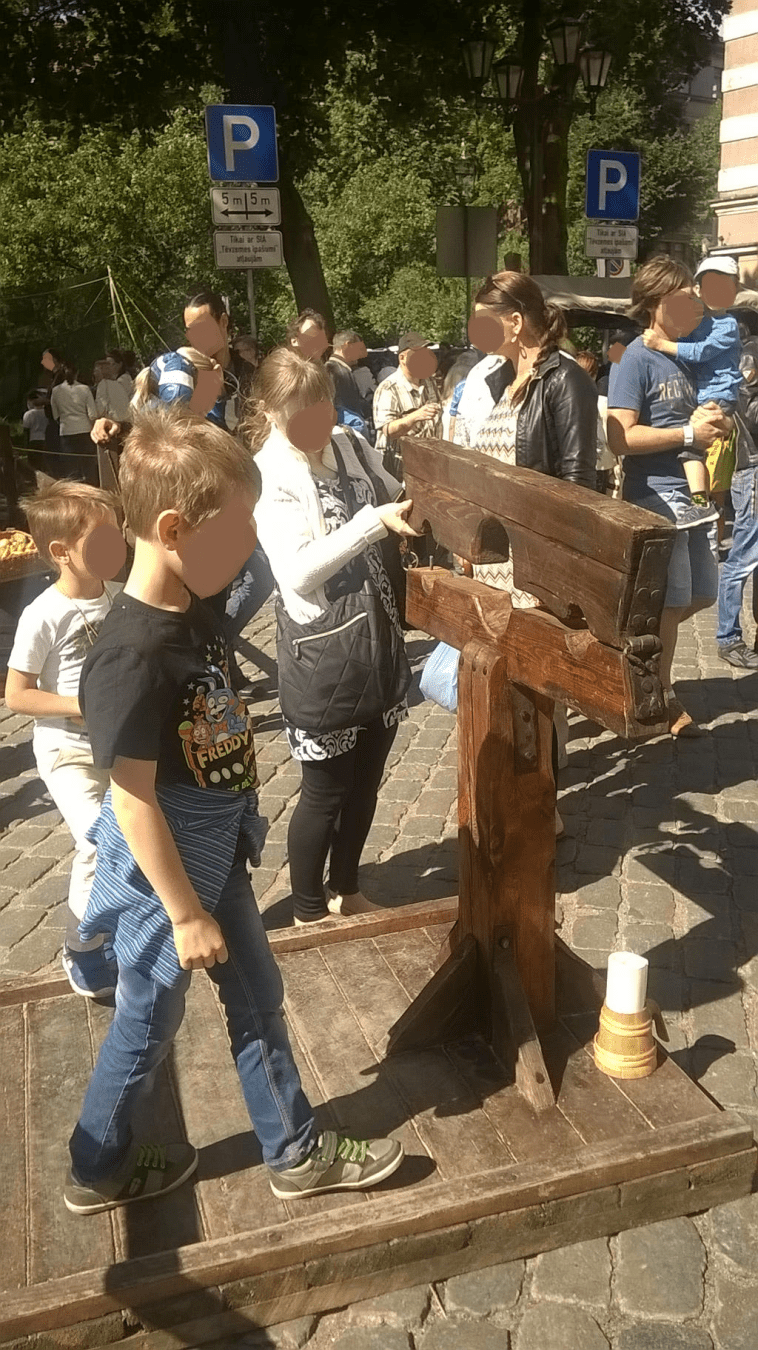 People checking out the stocks, that await for both its prisoner and worker...