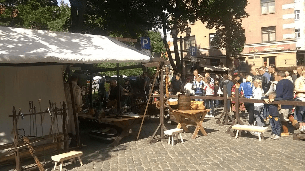 Area with weapons and some tools for entertainers, who are milling about the inside of the tent