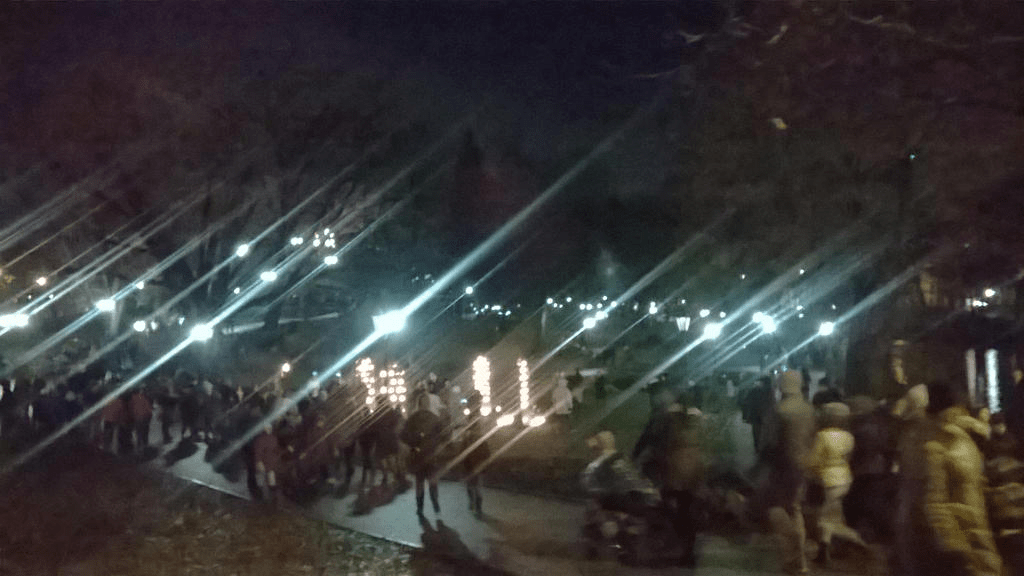 Bastionhill, bright with lights and art installations, with swarms of people walking through it