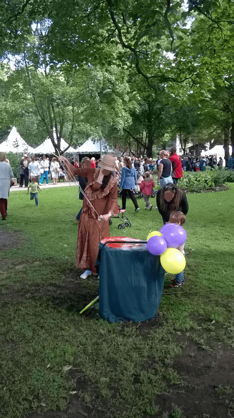 Lady in a costume readying the tools needed to make some big bubbles