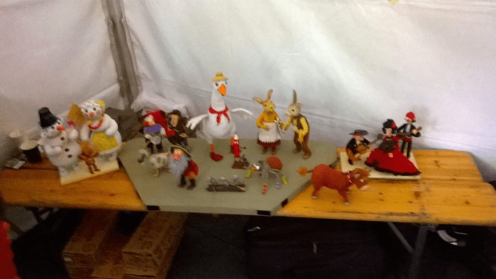 Photo of the dolls from various movies on a small table inside of the tent